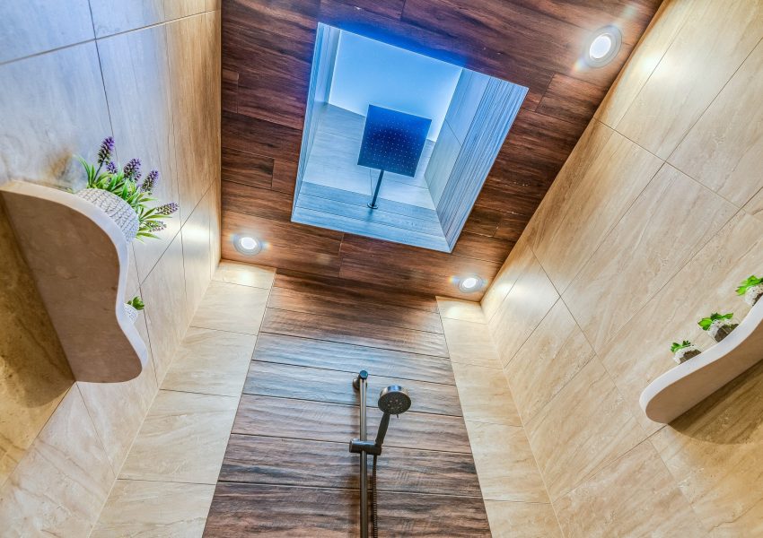 Warm colors and multi-textured tiles in master bath shower